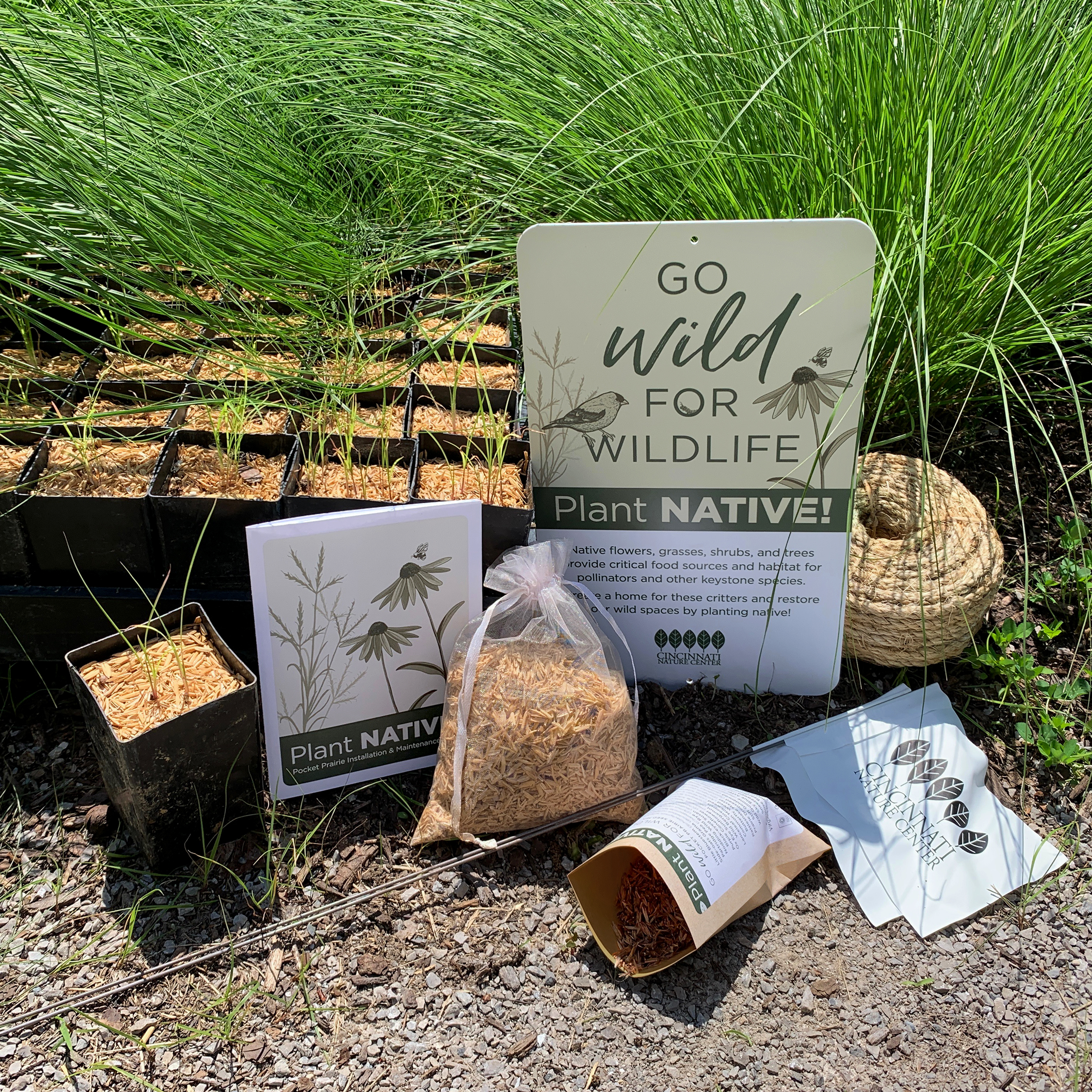 A photo of the pocket prairie kit, including seeds, signs, and more