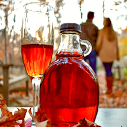 Maple syrup with couple in background.